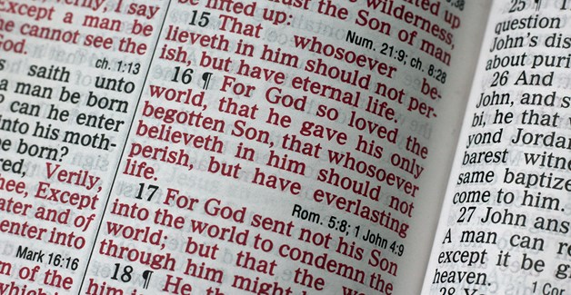 The Holy Bible open at John 3:16